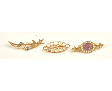 A gold, amethyst and seed pearl set brooch, mounted with the oval cut amethyst in a surround of seed pearls, a gold and moons