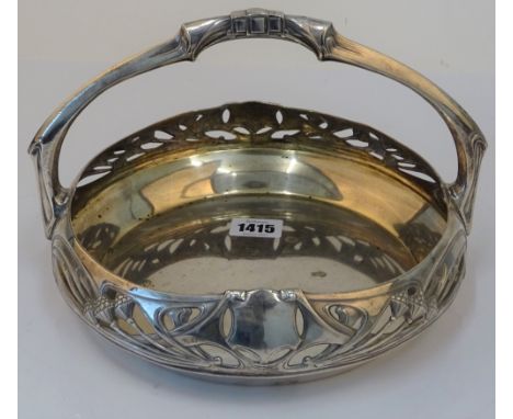An Art Nouveau circular cake basket, detailed A.P., European, early 20th century, with fixed overhead handle, the sides folia