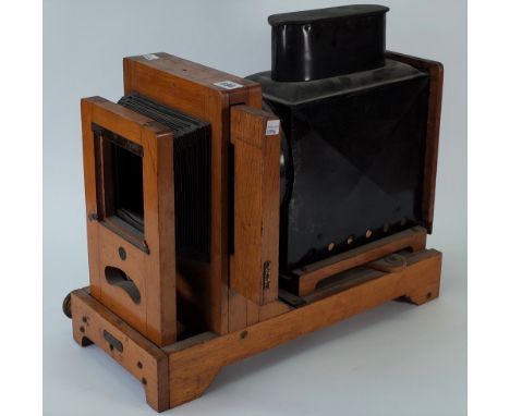 An early 20th century oak and tin horizontal enlarger, the front with an applied plaque detailed 'The Colonel Patent 14137/19