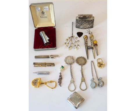 Two Egyptian key rings mounted with coins, a Gucci gilt metal key ring, two further key rings, a Ronson lighter with a case, 