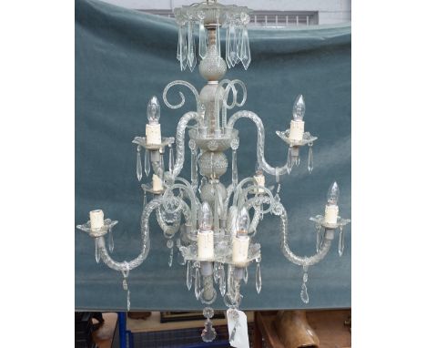 A 20th century Italian style glass nine light chandelier with spiral twist branches over two tiers and hung with cut glass dr