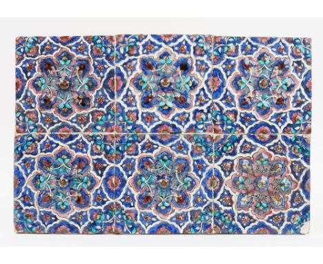 A Qajar moulded pottery tile panel, comprising of six square tiles, each moulded and painted with a central floral rosette fo