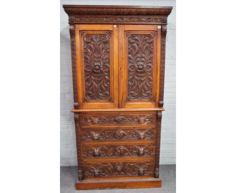 Edwards &amp; Roberts; A 19th century carved oak bedroom suite to comprise, linen press, 111cm wide x 211cm high, dressing ta