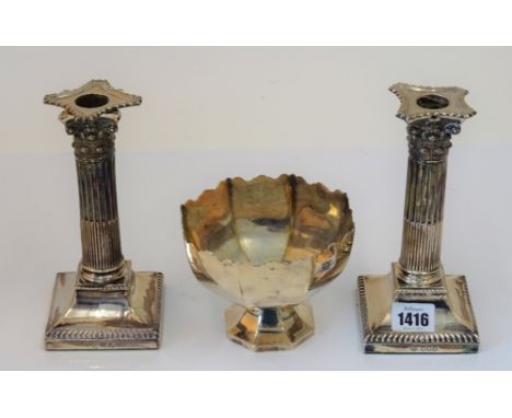 A pair of late Victorian silver candlesticks each designed as a Corinthian column, raised on a square base, London 1899, heig