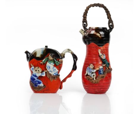 Two Sumidagawa teapots and covers, late 19th/20th century, each applied with two figures, each signed, 14cm and 21.5cm high, 