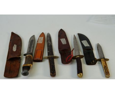 Two early 20th century bone handled hunting knives and two daggers, with leather sheaths, including an example by William Rod