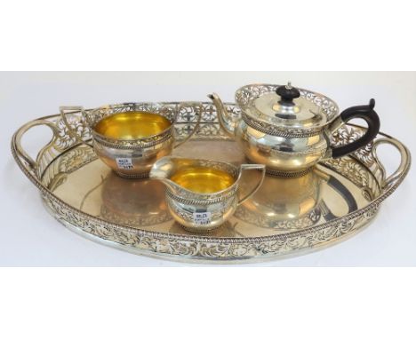 A silver three piece tea set and accompanying tray, comprising; a teapot, a twin handled sugar bowl and a milk jug, each piec