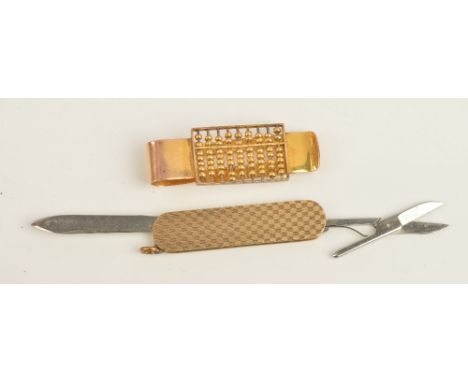 A gold money clip, designed as an abacus, detailed 14 K, weight 16.5 gms and a gold mounted folding pocket knife cum nail fil