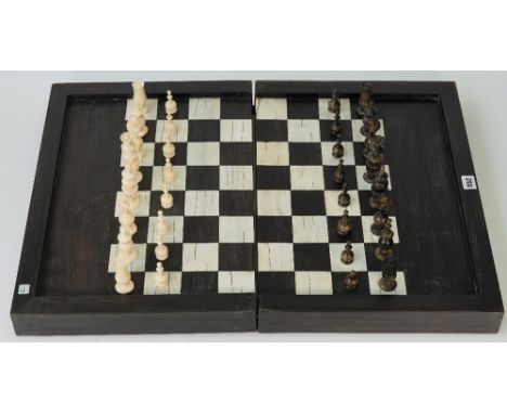 A French bone 'Regence' pattern chess set, nine ivory and nine ebony gaming counters and a folding ebony and bone inlaid ches