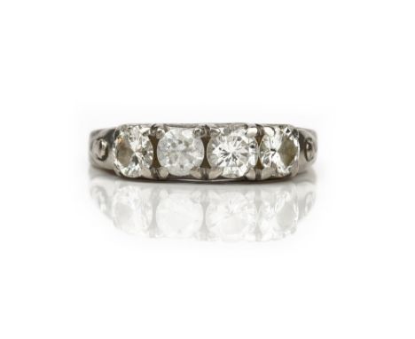 A white gold ring, mounted with three circular cut diamonds and with one replacement colourless gem, detailed 18 K, ring size