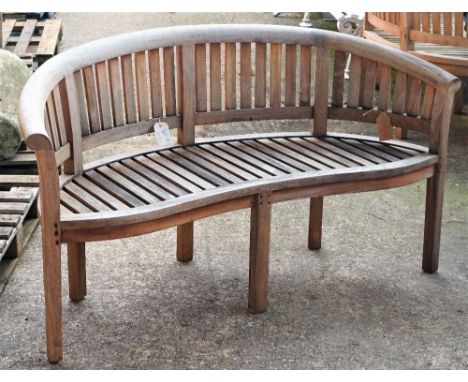 A teak framed semi-elliptic garden bench with slatted back and seat on block supports, 158cm wide x 85cm high.  Condition Rep