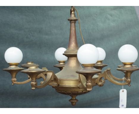 An Empire style brass eight light chandelier, 80cm wide x 62cm high. Condition Report Two glass bulbs are missing, tarnishing