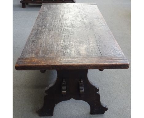 A 19th century Italian oak plank top kitchen table on trestle end standards united by double stretcher, 80cm wide x 181cm lon