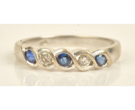 A white gold, sapphire and diamond set five stone ring, mounted with three circular cut sapphires alternating with two circul