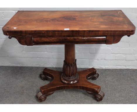 A Regency mahogany card table on carved and turned column and four scroll feet, 92cm wide x 72cm high. 