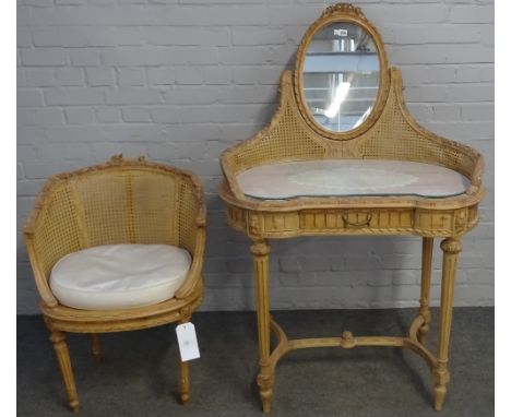 A Louis XVI style carved beech and cane work kidney shaped mirrored back dressing table, with a single frieze drawer on taper