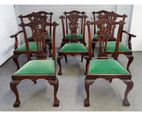 A set of eight 18th century style hardwood Chippendale revival dining chairs on claw and ball feet, to include a pair of carv