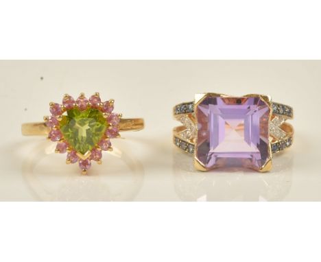 An 18ct gold, peridot and pink sapphire set heart shaped cluster ring, claw set with a heart shaped peridot at the centre, in