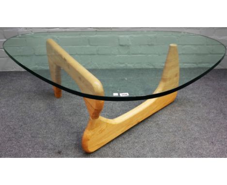 A Noguchi style glass and beech coffee table, 130cm wide x 40cm high. 