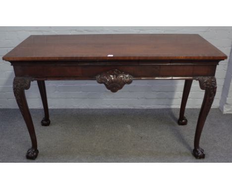 An Irish 18th century style walnut and mahogany serving table, the crossbanded rectangular top over shell carved frieze on ca