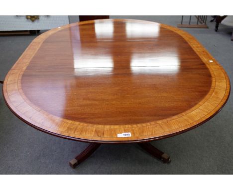 Possibly Brights of Nettlebed, a George III style satinwood banded circular extending dining table, on turned column and four