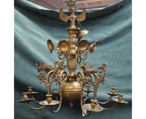 A brass eight light chandelier, the scroll branches having bird finials, in the 17th century style, 68cm high x 68cm diameter