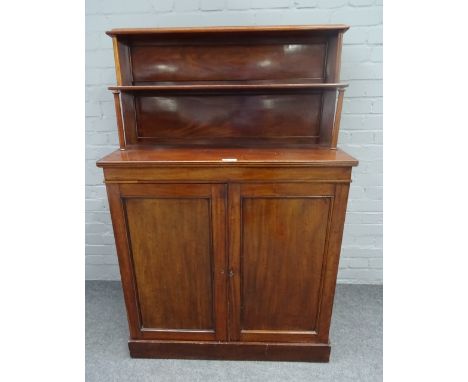 A Regency mahogany chiffonier, the two tier shelf back over pair of cupboards on plinth base, 94cm wide x 143cm high. Conditi