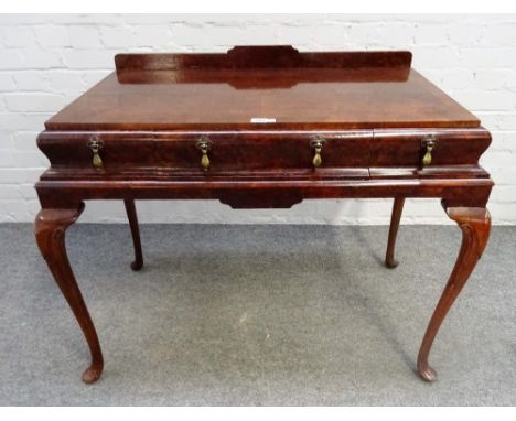 A George II style figured walnut side table, with three cushion frieze drawers, on cabriole supports, 100cm wide x 80cm high.