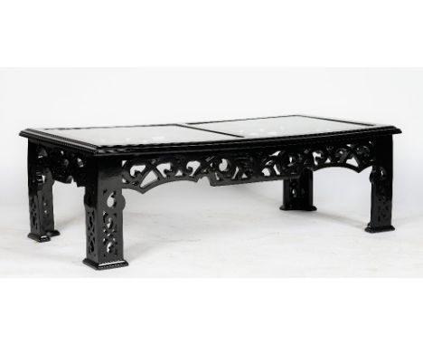 A black high gloss rectangular low cocktail table, in Chinese style, with fretwork friezes and legs, and double glass inset t