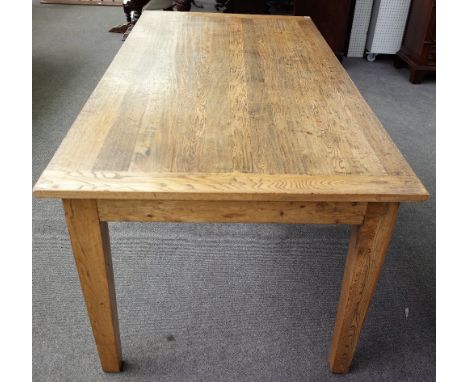 A modern distressed oak kitchen table, the cleated plank top on tapering square supports, 100cm wide x 210cm high. 