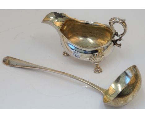 A silver rat tail pattern soup ladle, London 1901, weight 270 gms and a plated sauceboat, raised on three shell capped paw fe