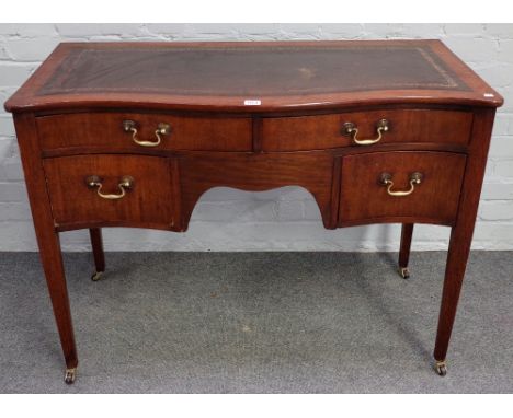 A George III style mahogany serpentine writing table with four frieze drawers on tapering square supports, 102cm wide x 76cm 