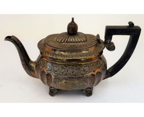 A silver teapot, with partly fluted decoration below a floral and foliate engraved band, raised on four feet, London 1901, gr