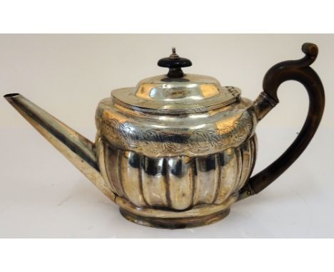 A George III silver teapot, of oval fluted form, decorated with an engraved band, with a straight tapered spout, London 1799,