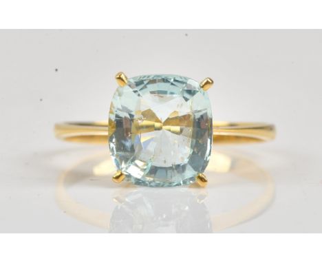 A gold ring, claw set with a cushion shaped aquamarine, detailed indistinctly 750, ring size Q, gross weight 2.3 gms.