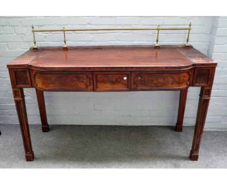 A Regency mahogany breakfront serving table with a pair of central drawers, flanked by lift top compartments on channelled bl