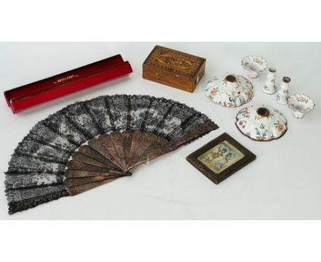 A black lace fan, late 19th century, with pierced and carved mother-of-pearl stick, 52cm across, in red silver covered Duvell