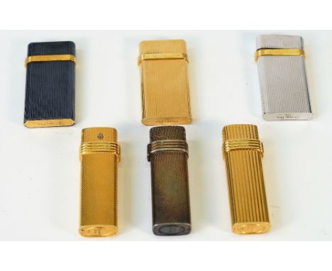 A collection of six Christian Dior lighters, all engine turned, four with a ribbed design, (6) Condition Report All with gene