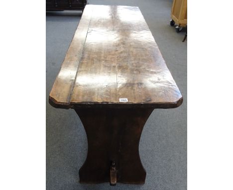 A 17th century and later fruitwood tavern table on slab end supports united by a stretcher, 53cm wide x 183cm long. Condition