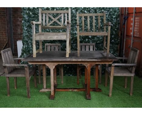 A teak rectangular extending garden table, 90cm wide x 160cm long, together with four armchairs and two further similar, (7).