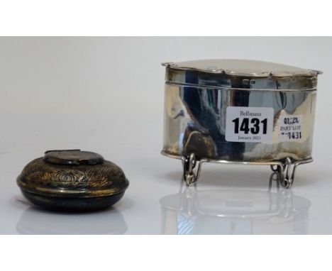 A silver oval hinge lidded tea caddy, raised on four wirework feet, Birmingham 1904, weight 162 gms and an Egyptian circular 