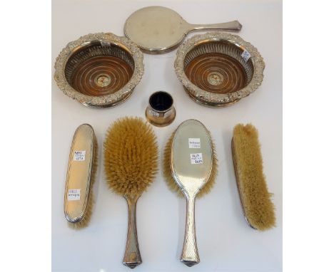 A silver mounted five piece dressing set, comprising; a hand mirror, two hairbrushes and two clothes brushes, mostly London 1