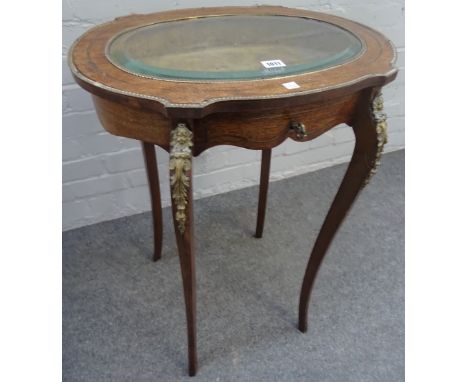 A late 19th century French gilt metal mounted mahogany oval bijouterie table, with bevelled glass top on cabriole supports, 5