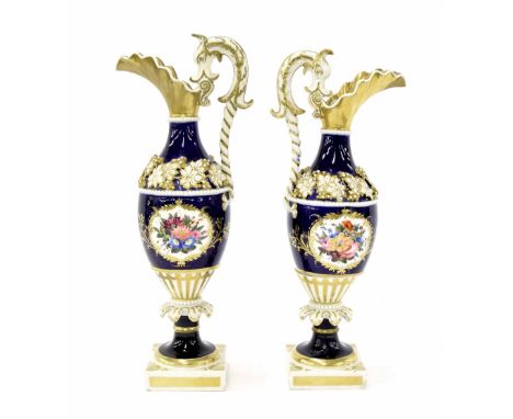 Pair of Chamberlains Worcester porcelain baluster ewers, each with gilded scallop spouts, wrythen fluted seahorse handles and