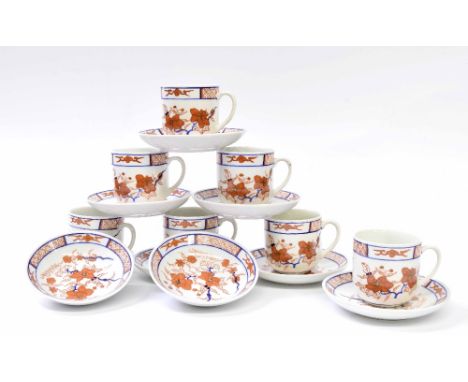 Seven Chinese coffee cups on saucers, decorated with orchids, together with two further saucers
