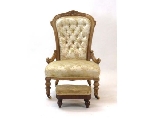 A Victorian walnut and button upholstered armchair on turned feet with castors together with a Victorian foot stool   CONDITI