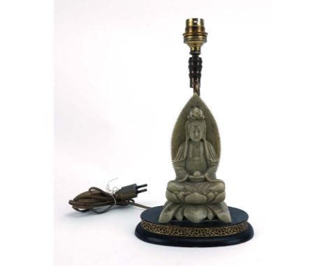 A Chinese soapstone carving modelled a Guanyin seated on a lotus base, currently used as a table lamp, overall h. including f