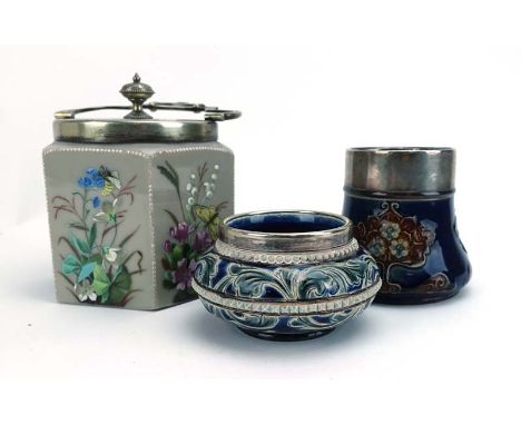 A Royal Doulton mug, typically decorated with stylised flowerheads on a blue ground, silver mount, h. 9 cm (af), together wit