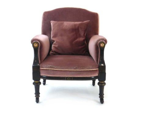 A Victorian ebonised, gilt highlighted and upholstered armchair, the arm ends inset with enamelled portrait plaques CONDITION