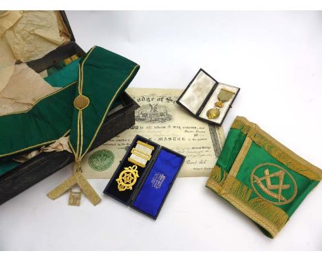 Masonic Interest: a tole case containing apron, arm bands, sash etc. together with two cased gilt metal jewels and a certific